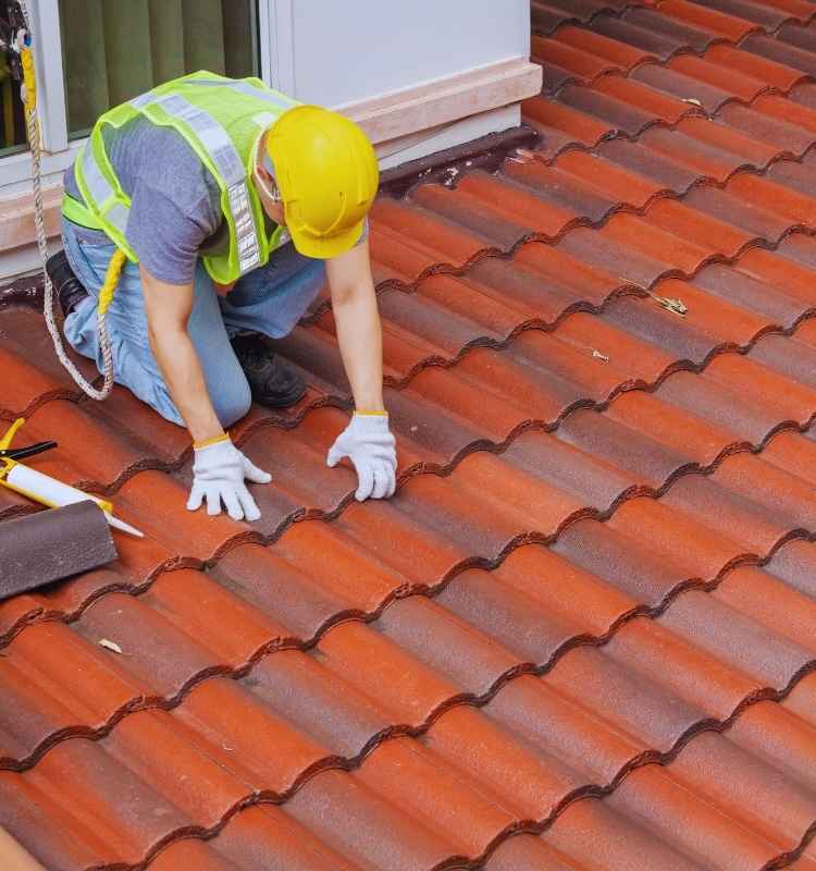 roof contractor working on shingle roof